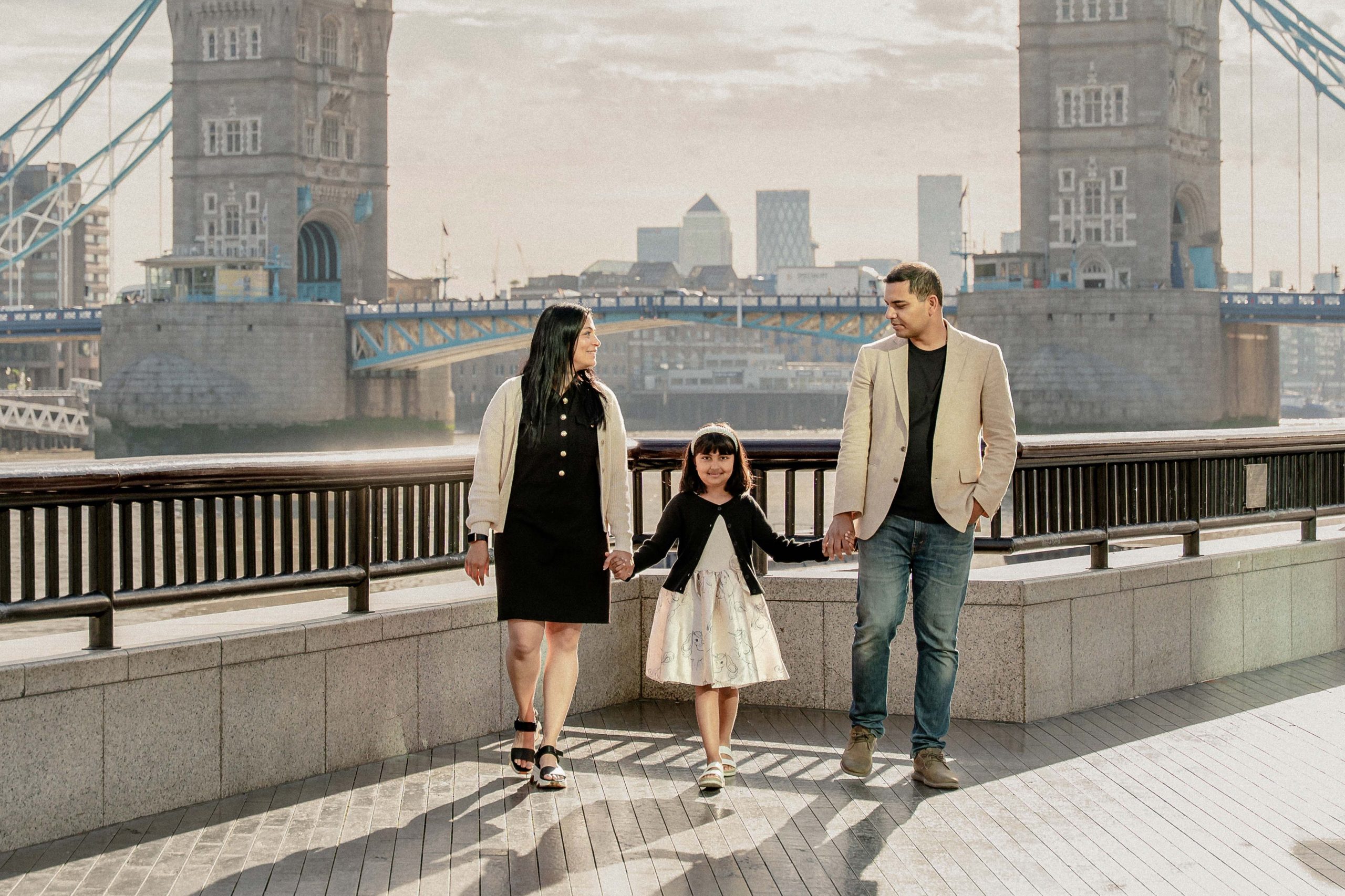 Sweet family posed in front of tower bridge London. Photo Captered by London Snap - A Cinematic Candid best affordable Phtotoshot and Reels creation company